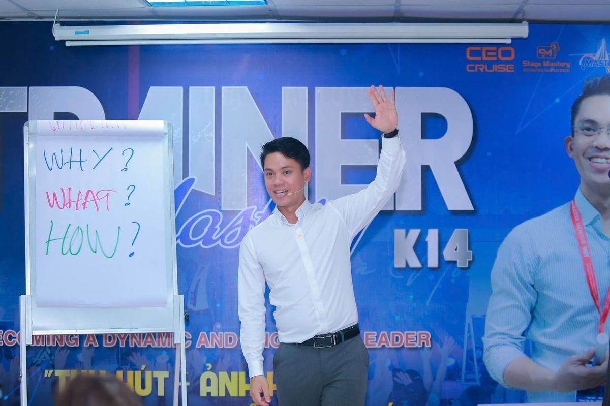 Lê Văn Cương đứng lớp Trainer Mastery khoá 14, cạnh bảng lật ghi Why, What, How